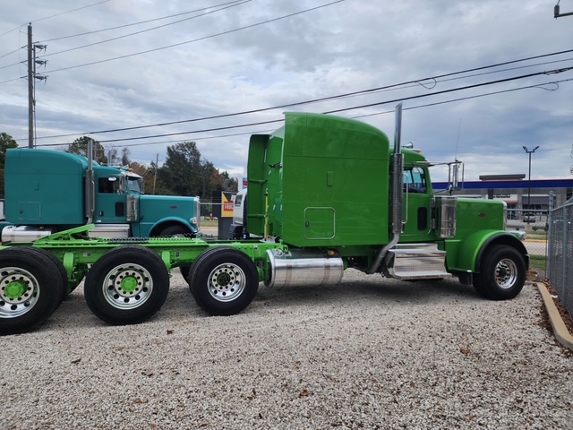 Green Peterbilt heavy haul tractor side profile at the Houston terminal